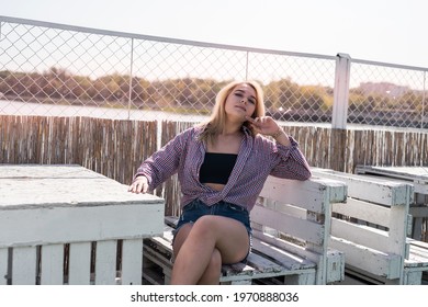 portrait of pret woman sitting on wooden chair, enjoy summer hot sunny day - Shutterstock ID 1970888036