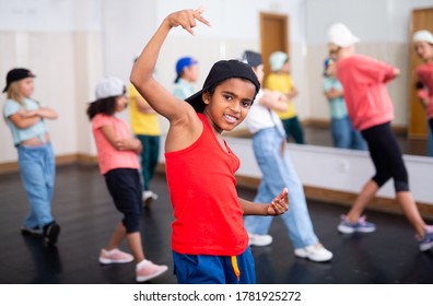 Portrait Of Preteen Afro-American Boy Performing Hip Hop At Group Dance Class