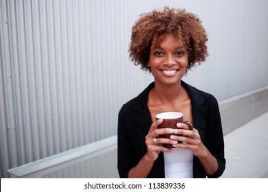 portrait of a pretty African American executive holding a mug