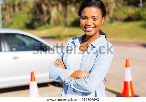portrait of pretty african student driver in\
testing ground