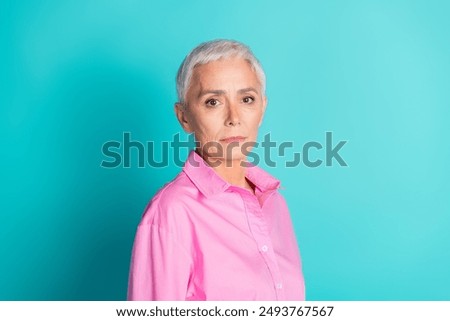 Portrait of pretty aged lady empty space wear pink shirt isolated on turquoise color background