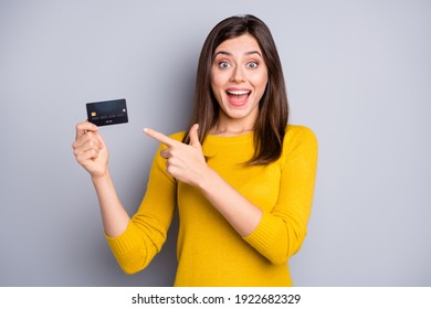Portrait of pretty amazed glad cheerful girl holding in hands demonstrating bank card novelty isolated over grey color background - Shutterstock ID 1922682329