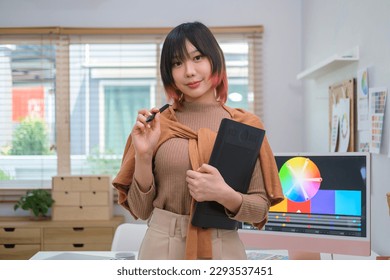 Portrait of pretty asian female  interior designer in stylish clothes standing at creative office. - Powered by Shutterstock