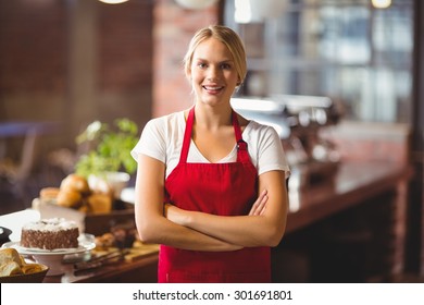 Portrait of a pretty barista with arms crossed at the coffee shop - Powered by Shutterstock