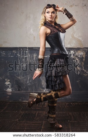 Portrait of pretty beautiful steampunk woman in Aviator glasses over grunge background.