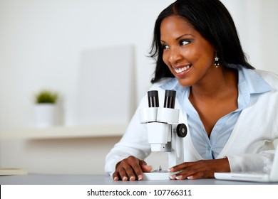 Portrait Of A Pretty Black Woman Working With A Microscope At Laboratory