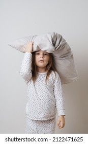 Portrait Of Pretty Caucasian Girl In White Pyjama And Pillow In Studio White Background 