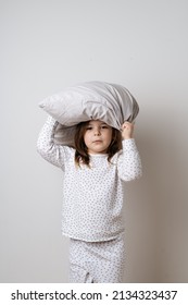 Portrait Of Pretty Caucasian Girl In White Pyjama And Pillow In Studio White Background 