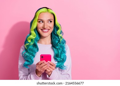 Portrait of pretty cheerful girl look interested empty space hold telephone isolated on pink color background - Powered by Shutterstock