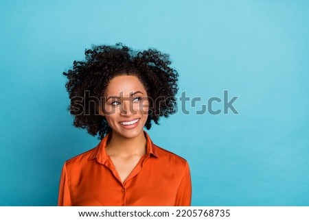 Portrait of pretty cheerful person beaming smile look empty space isolated on blue color background