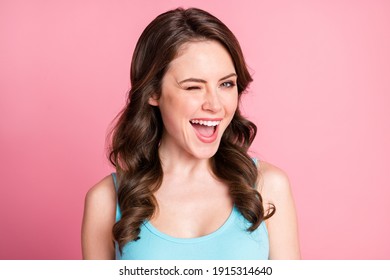Portrait of pretty coquettish brunette girl wink wear blue top isolated on pink color background