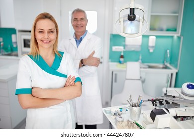 Portrait of pretty female dental assistant with dentist in dental clinic - Shutterstock ID 444247807