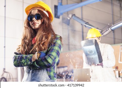 Portrait Of Pretty Female Worker In A Steel Mill