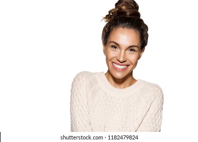 Portrait of pretty girl cheerfully smiling wearing cozy knitted sweater on white background.  Copy space in left side. Winter and beauty concept