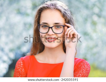 Portrait pretty girl in glasses outdoors in spring day