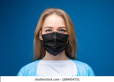 Portrait Of Pretty Girl With Long Fair Hair With Medical Mask On Her Face, Picture Isolated On Blue Background