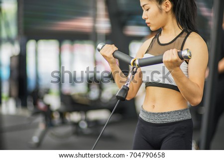Portrait of pretty girl training on special sport equipment in gym