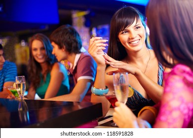 Portrait of pretty girls talking at party in the bar - Powered by Shutterstock