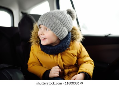 Portrait Of Pretty Little Boy Sitting In Car Seat During Roadtrip Or Travel. Family Car Travel With Kids. Child Transportation Safety