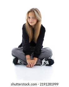 Portrait Of Pretty Long Hair Girl Isolated On White Background. Teen Woman Sitting Cross Legged And Smile Into Camera.