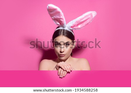 Portrait of a pretty lovely girl wearing bunny ears isolated on pink banner, copy space. Blank poster banner