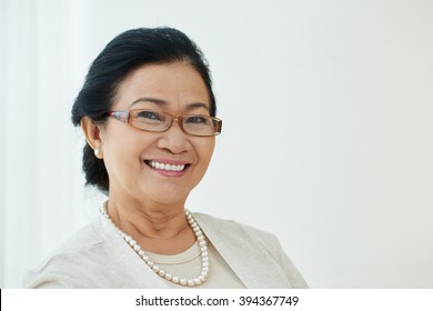 Portrait Of Pretty Mature Vietnamese Woman Smiling At Camera