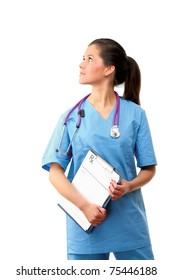 Portrait Of A Pretty Nurse With A Clipboard Looking Up