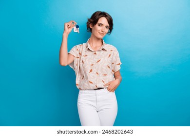 Portrait of pretty positive girl hand hold demonstrate new apartment key isolated on blue color background - Powered by Shutterstock