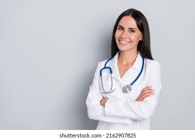 Portrait of pretty positive lady crossed hands empty space blank isolated on grey color background - Powered by Shutterstock