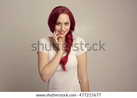 portrait of a pretty red haired woman wearing a white shirt, with an over the top emotional expression.