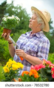 Portrait Of Pretty Senior Woman Gardening