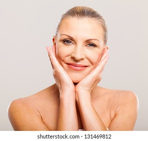 Portrait Of Pretty Senior Woman With Hands On Her Face