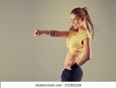 Portrait of pretty smiling athletic female dancing zumba aerobics in the gym. Concept of sport, dance and lifestyle.