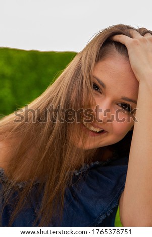 Portrait of pretty smiling young teen girl enjoying time outside on a summer day.