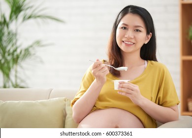 Portrait Of Pretty Vietnamese Woman Eating Probiotic Yogurt