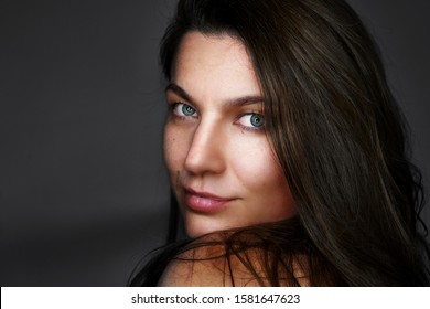 Portrait Of Pretty Woman Dark Hair, Blue Eyes. Natural Smile.  Smiling  Beautiful