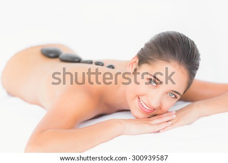 Portrait of a pretty woman enjoying a hot stone massage at the health spa