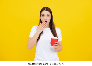 Portrait Of A Pretty Woman Holding Takeaway Coffee Cup Isolated Over Yellow Background.