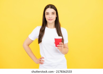 Portrait Of A Pretty Woman Holding Takeaway Coffee Cup Isolated Over Yellow Background.