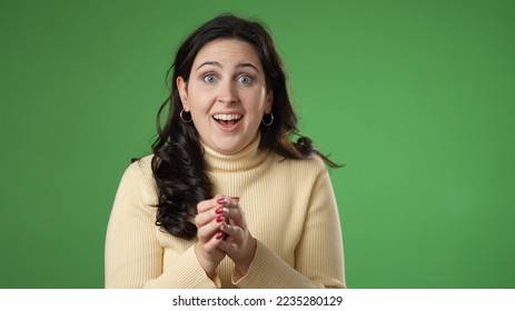 Portrait of pretty young 20s woman getting great success winner isolated over green screen background in studio. People sincere emotions, lifestyle concept. Looking at the camera - Powered by Shutterstock