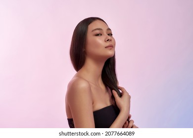 Portrait Of Pretty Young Asian Woman Isolated On Pink Studio Background Show Thick Healthy Hair After Salon Procedures. Happy Beautiful Millennial Vietnamese Girl Model. Beauty Industry, Haircare.