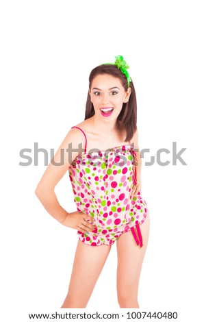 Portrait of pretty young brunette woman in colorful pajamas in the studio, isolated on a white background