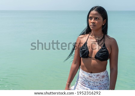 Portrait of a pretty young brunette woman on the beach