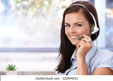 Portrait Of Pretty Young Dispatcher Smiling, Looking At Camera.