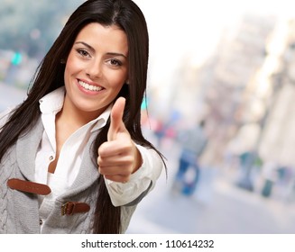 Portrait Of A Pretty Young Girl Doing Good Gesture At Street