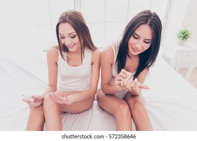 Portrait Of Pretty Young Girls Painting Nails At Home.