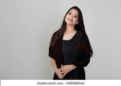 Portrait Of Pretty Young Indian Girl With Long Dark Hair Standing Against White Background, Beautiful Model For Advertisement.