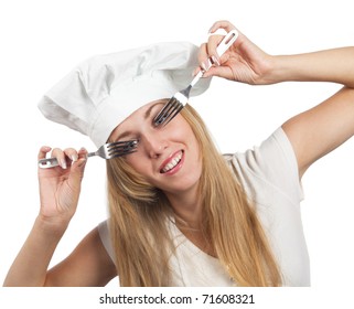 Portrait of a pretty young smiling  uniformed female Chef looking through forks
