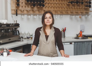 Portrait Of Pretty Young Waitress Standingin Cafeteria Behind The Counter