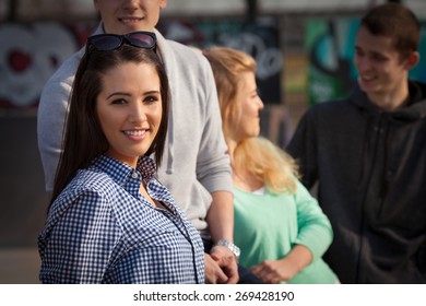 Portrait Of Pretty Young Woman Hanging Out With Her Friends